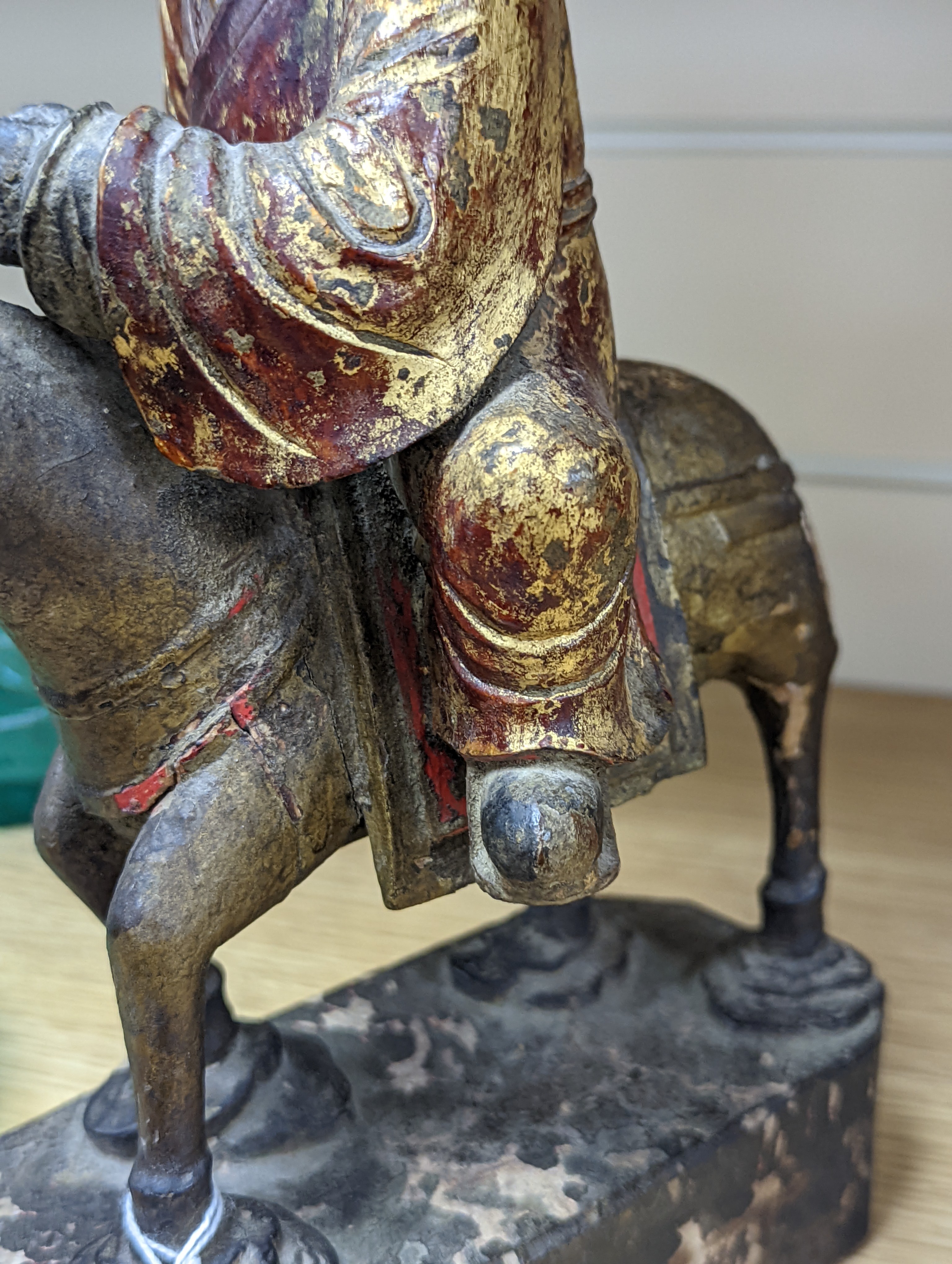 An 18th/19th century Chinese lacquered wood group of an official riding a horse, 30cm